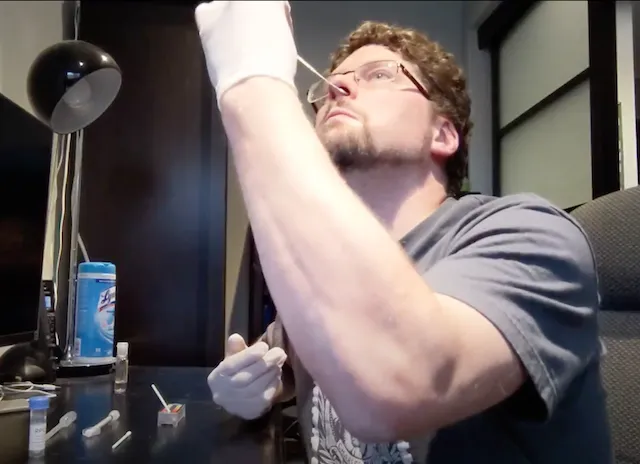 Self-administering a nasopharyngeal swab